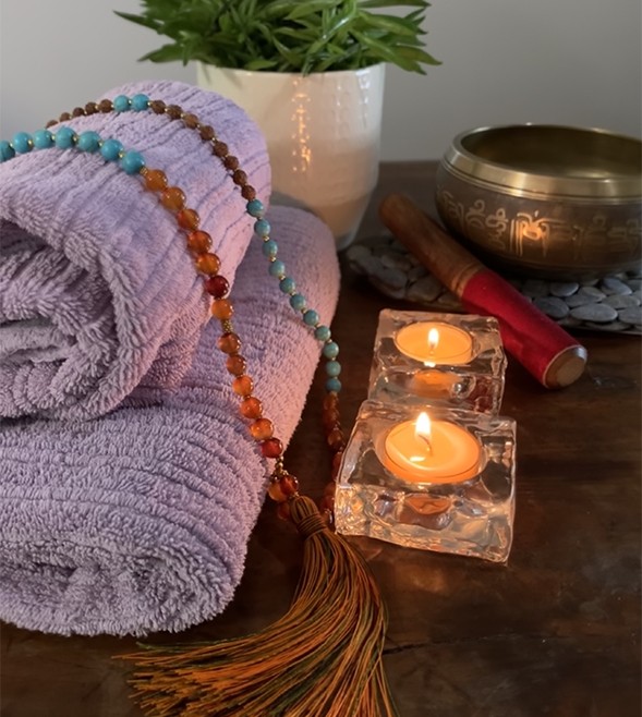 candles-towels-tibetan-beads-singing-bowl-on-a-table