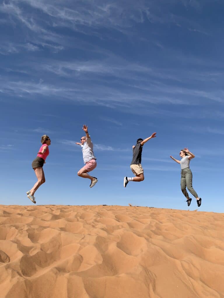 people-jumping-desert-sand